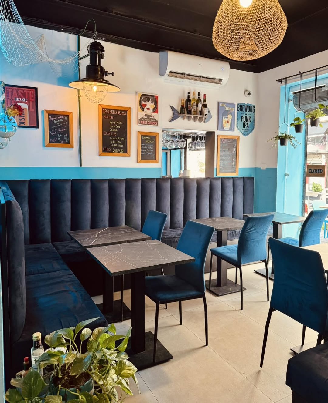 Cosy banquette seating with bestseller chalkboards at Forty Fishes St Julian's